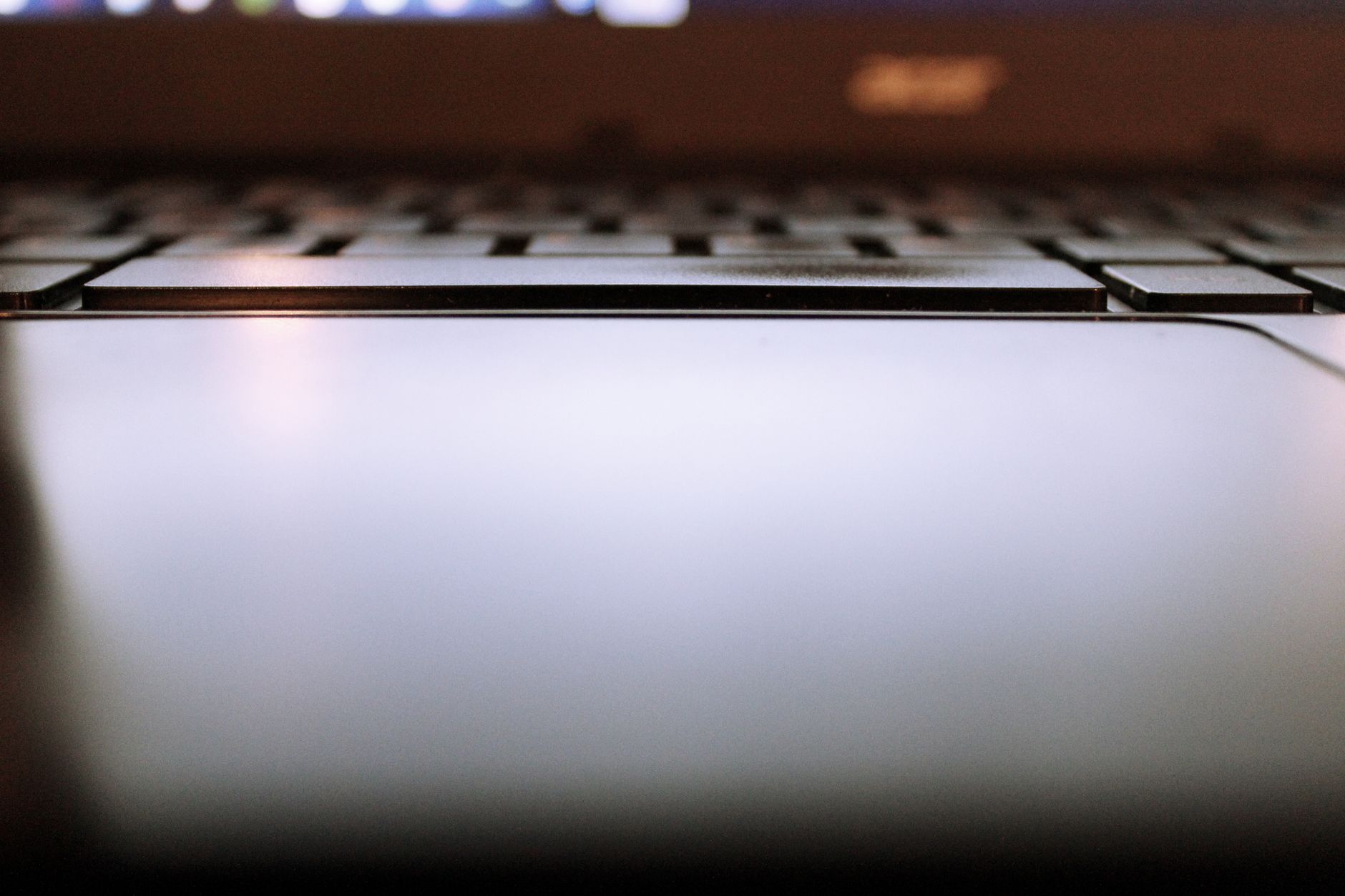 Photo: close-up of a laptop keyboard and trackpad.