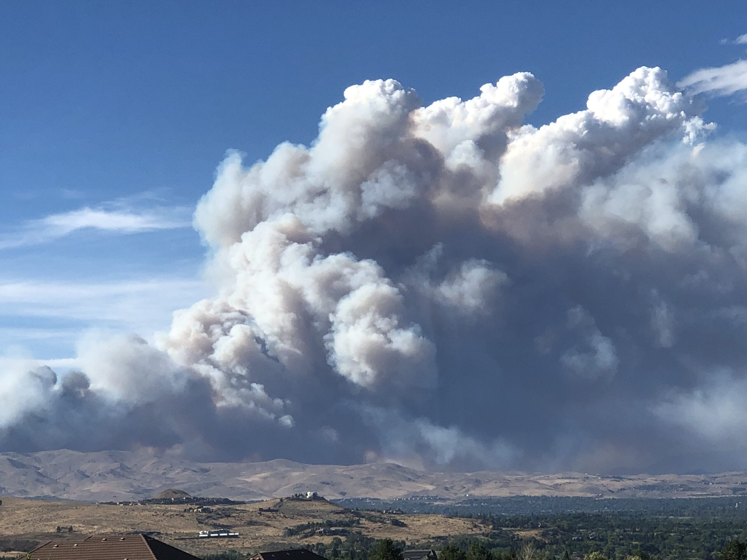 Massive smoke plume from the Hawk Fire rises over hillsides near Reno, Nevada