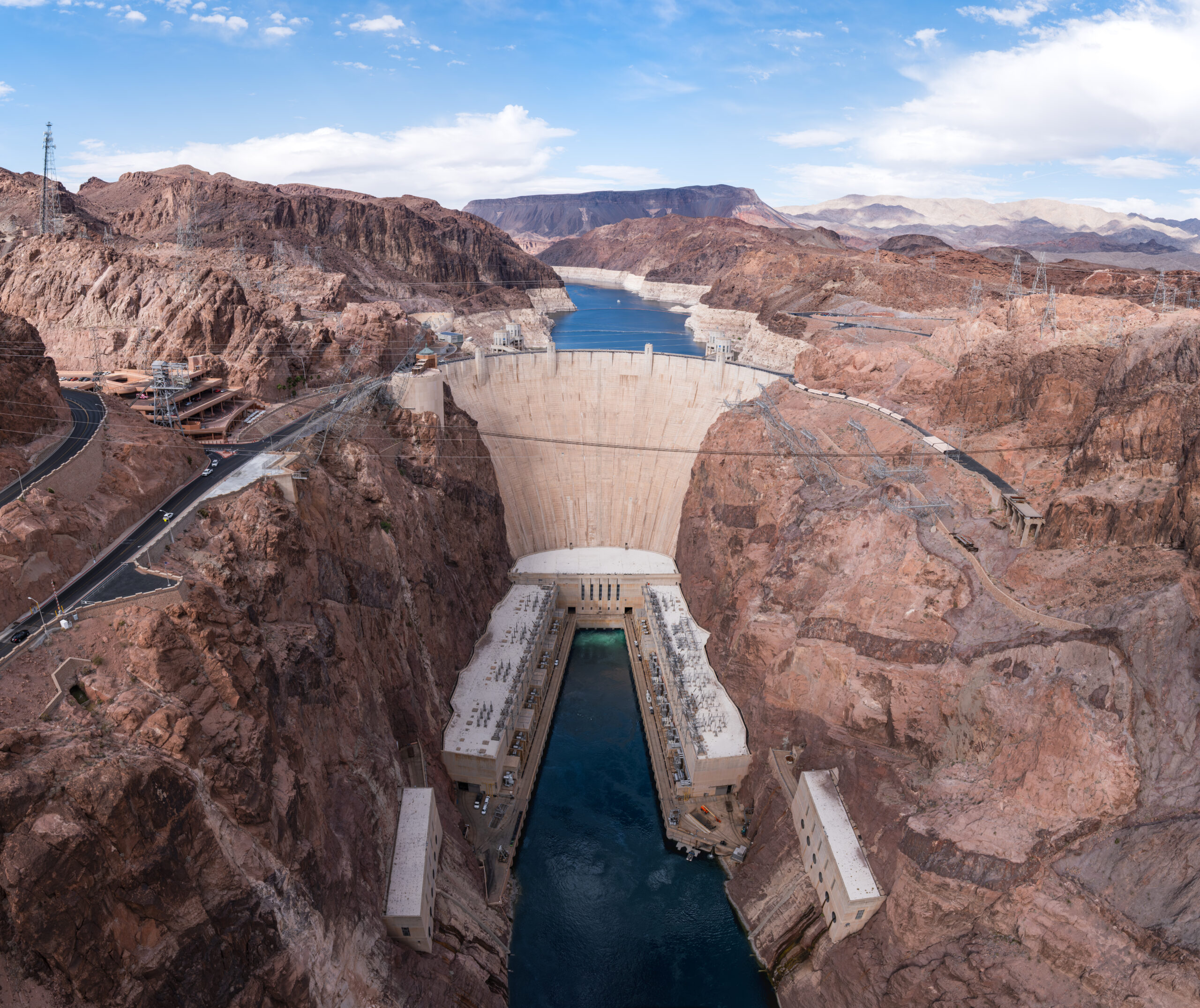 Hoover Dam with Lake Mead visible behind it, showing the pale mineral 'bathtub ring' left by falling water levels