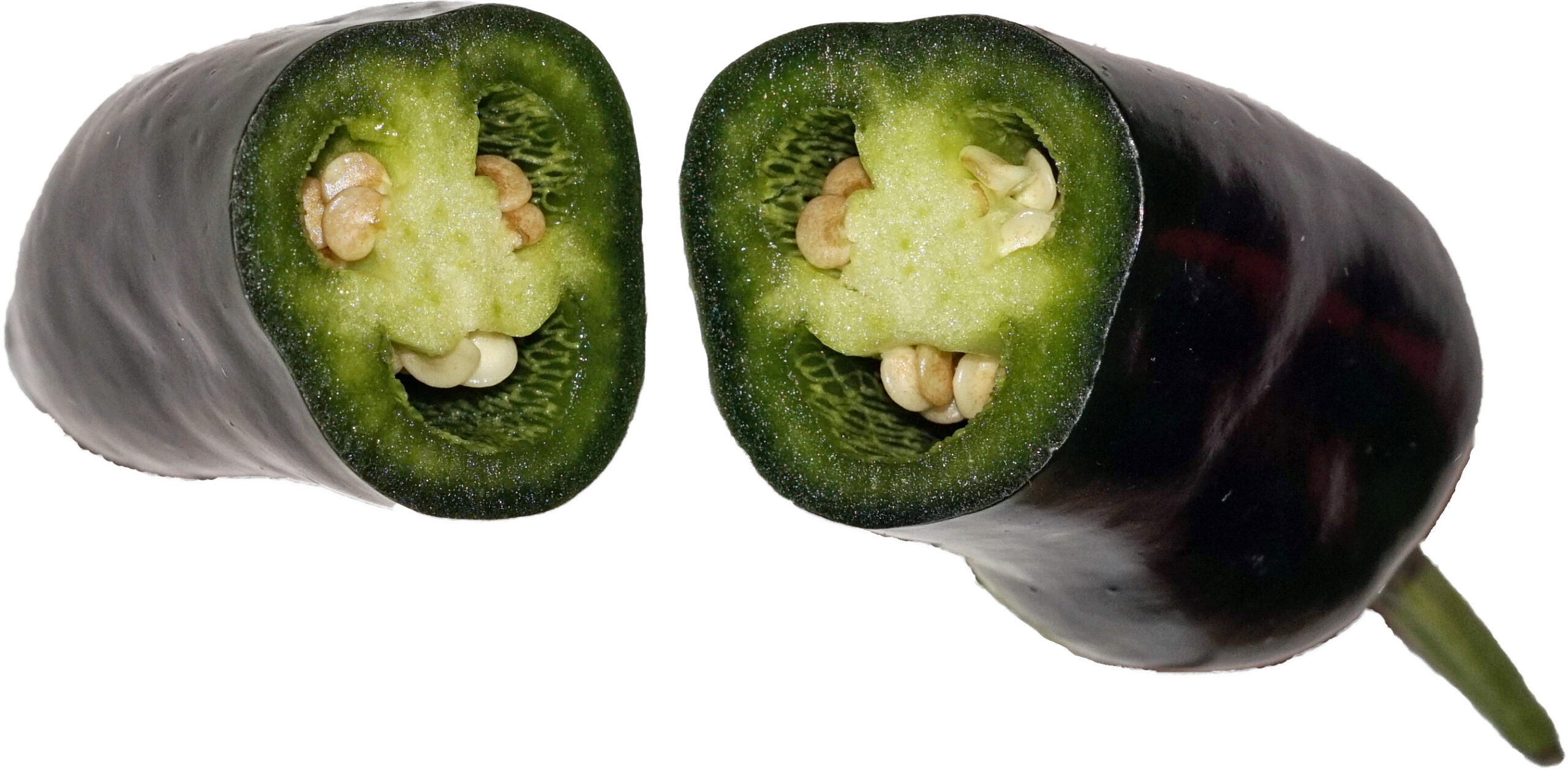 A jalapeño pepper cut crosswise into two pieces, showing the pale inner flesh and seeds, on a white background.