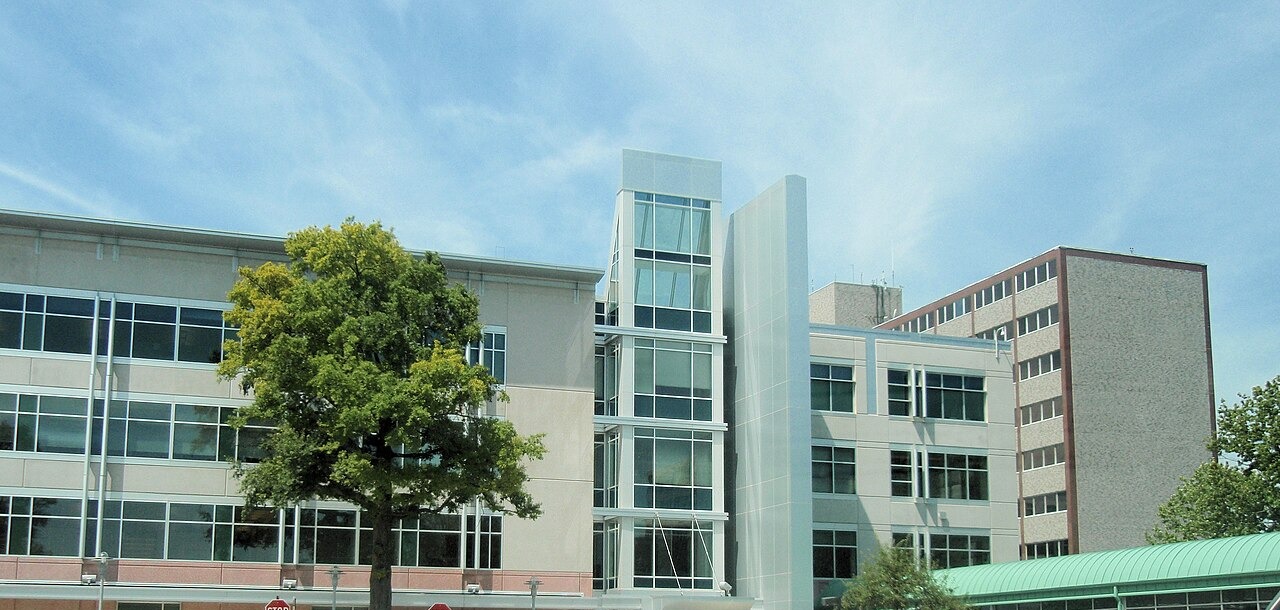 The Social Security Administration's headquarters building in Woodlawn, Maryland, seen from the parking area on a clear day.