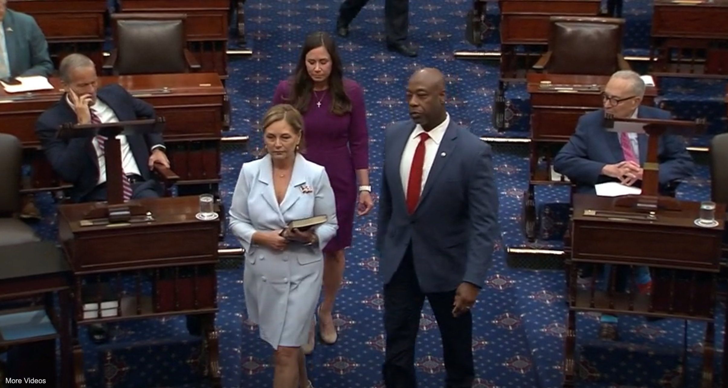 Sen. Darline Graham, accompanied by Sen. Tim Scott, on the Senate floor during her swearing-in ceremony.