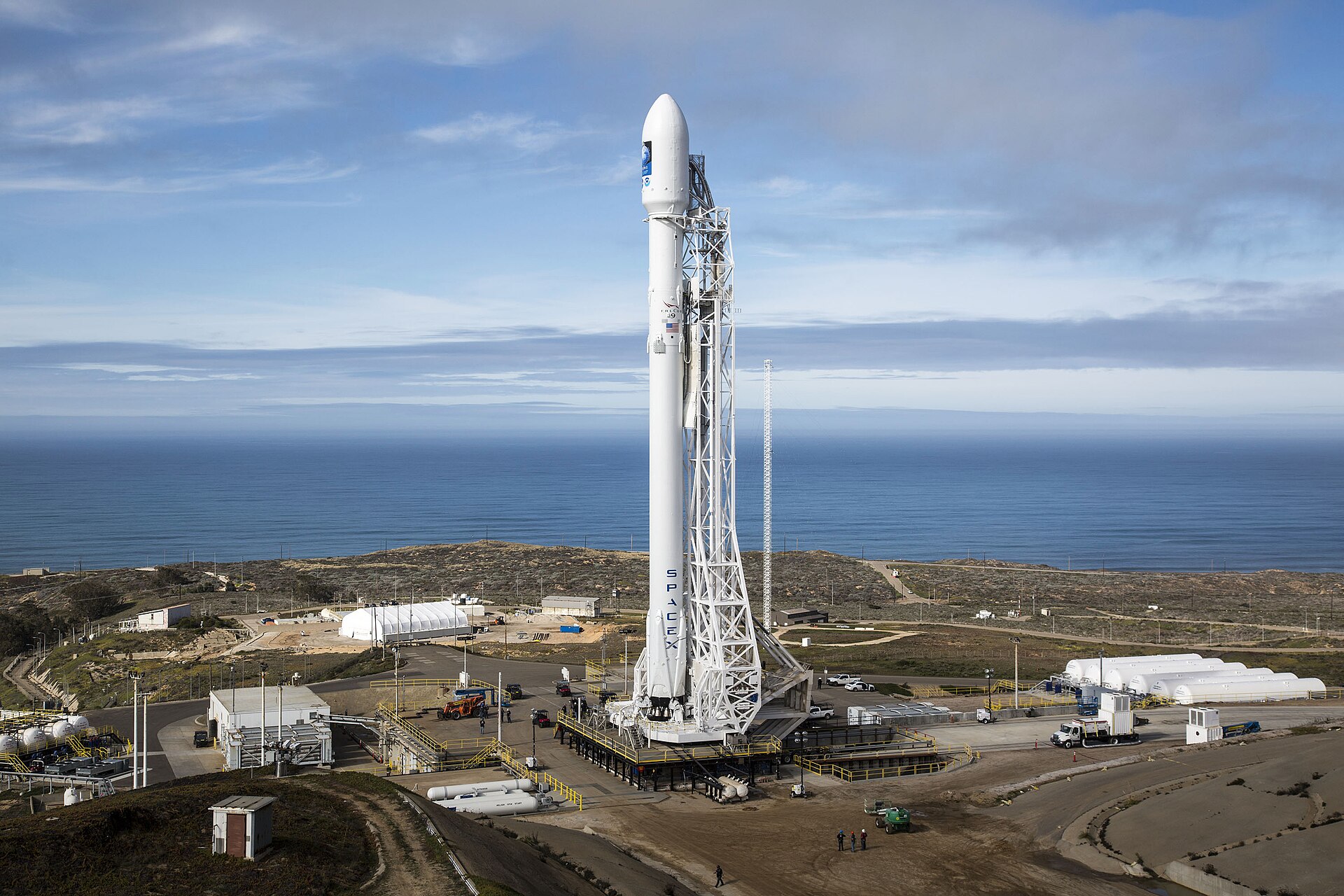 A SpaceX Falcon 9 rocket standing vertical on its launch pad