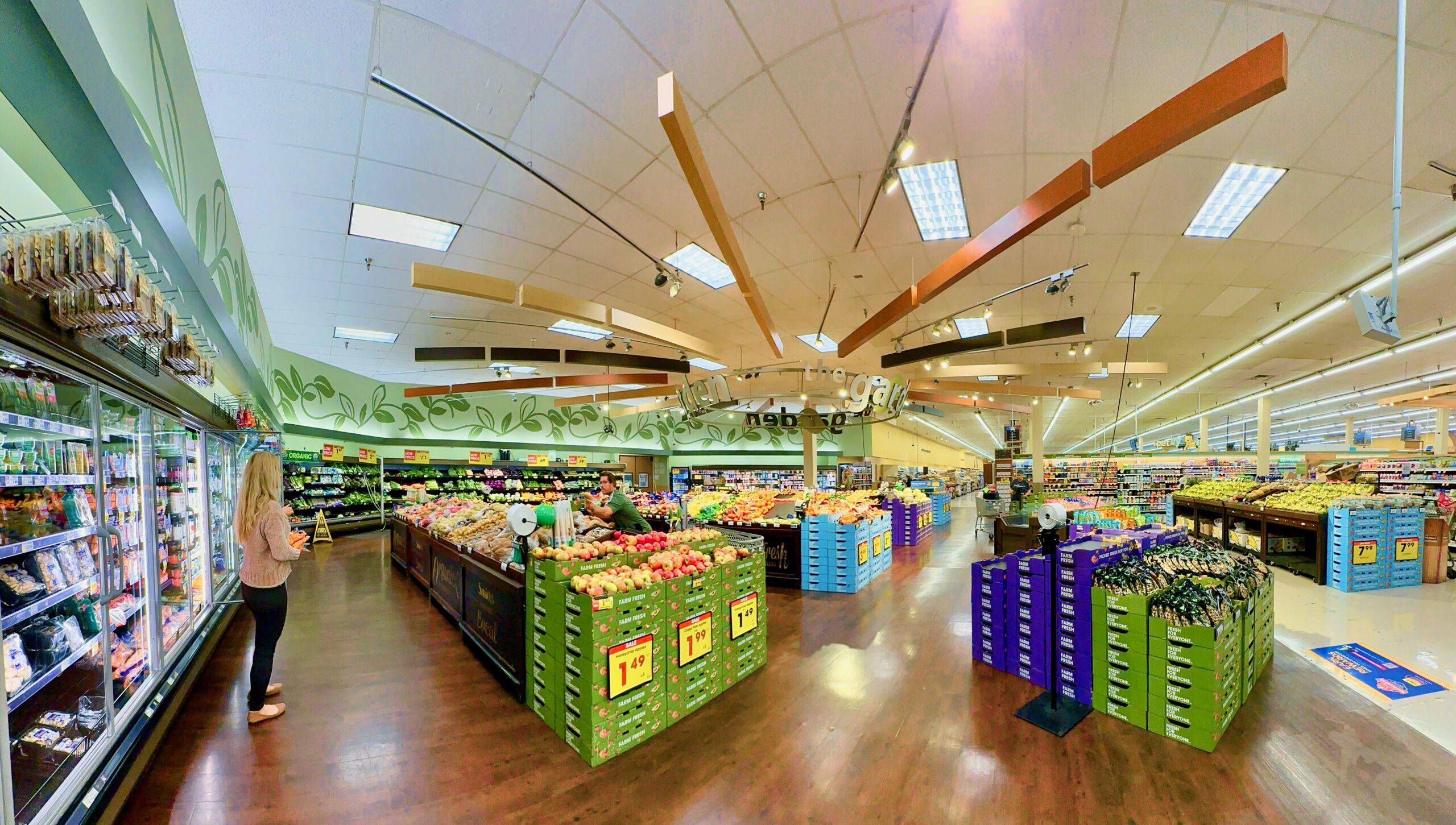 The produce aisle of a U.S. grocery store, with shelf price tags visible.