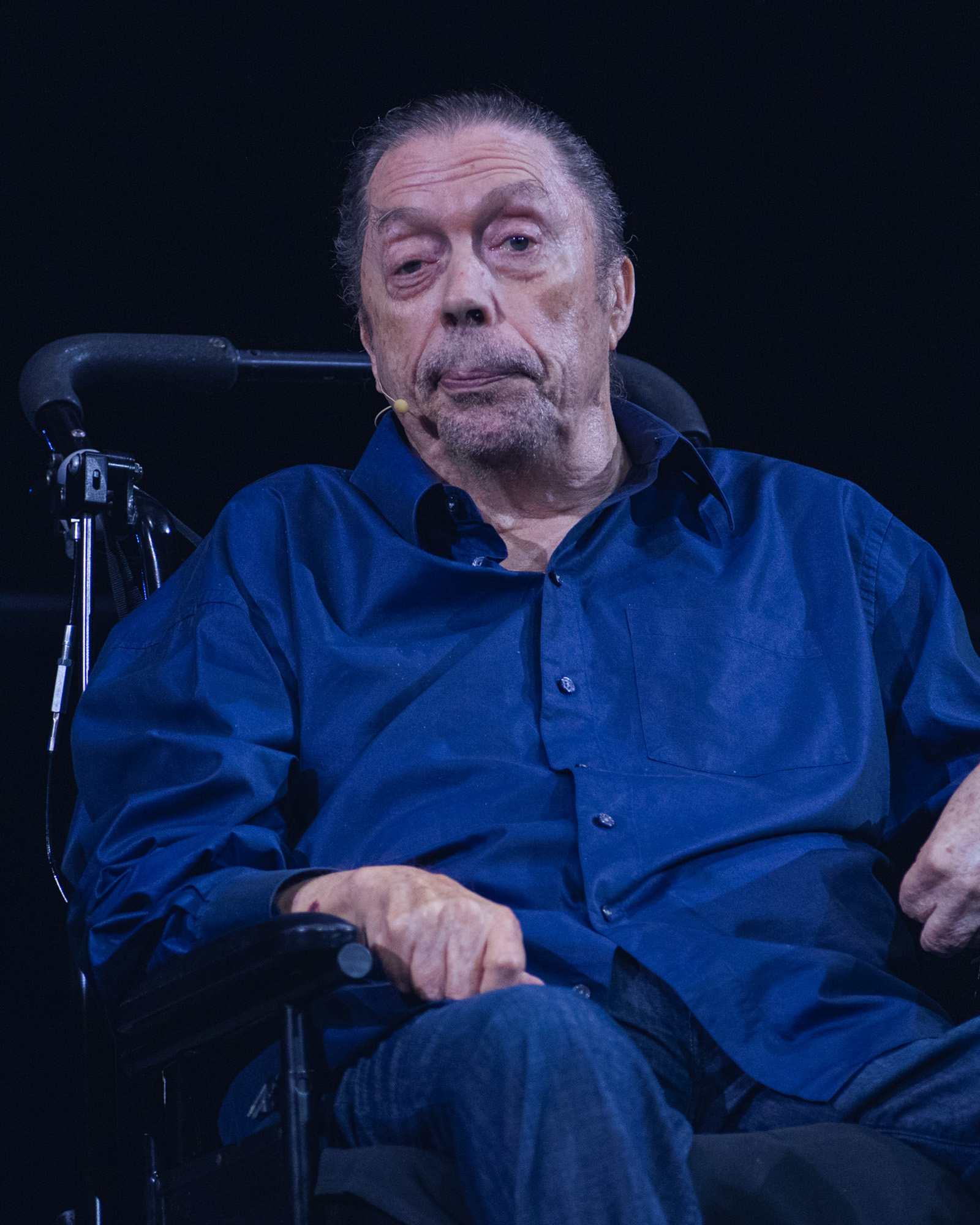 Tim Curry seated in a wheelchair on stage at the Academy Museum's 50th-anniversary celebration of The Rocky Horror Picture Show, September 26, 2025.