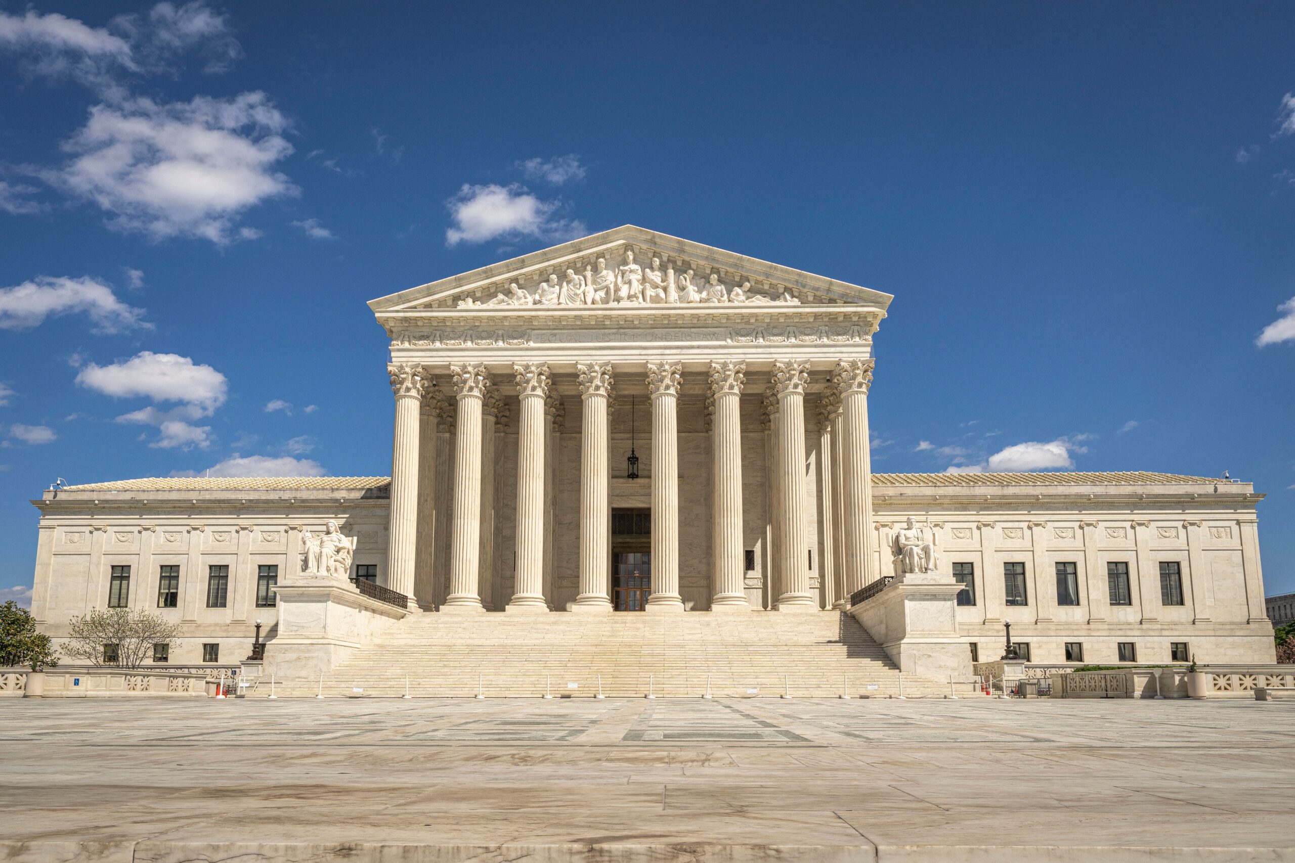 The United States Supreme Court building facade under a clear sky