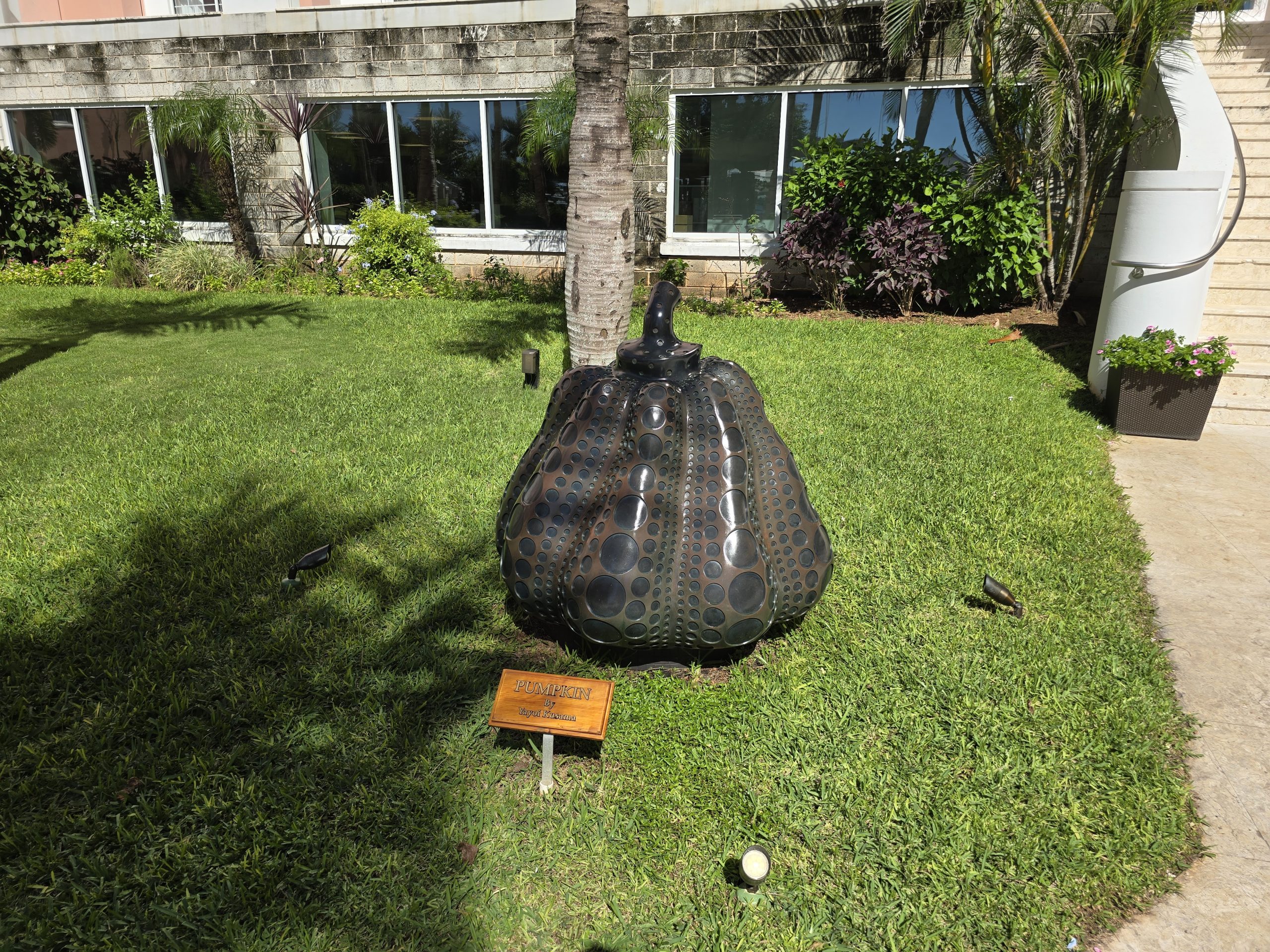 Yayoi Kusama's polka-dot Pumpkin sculpture on a lawn