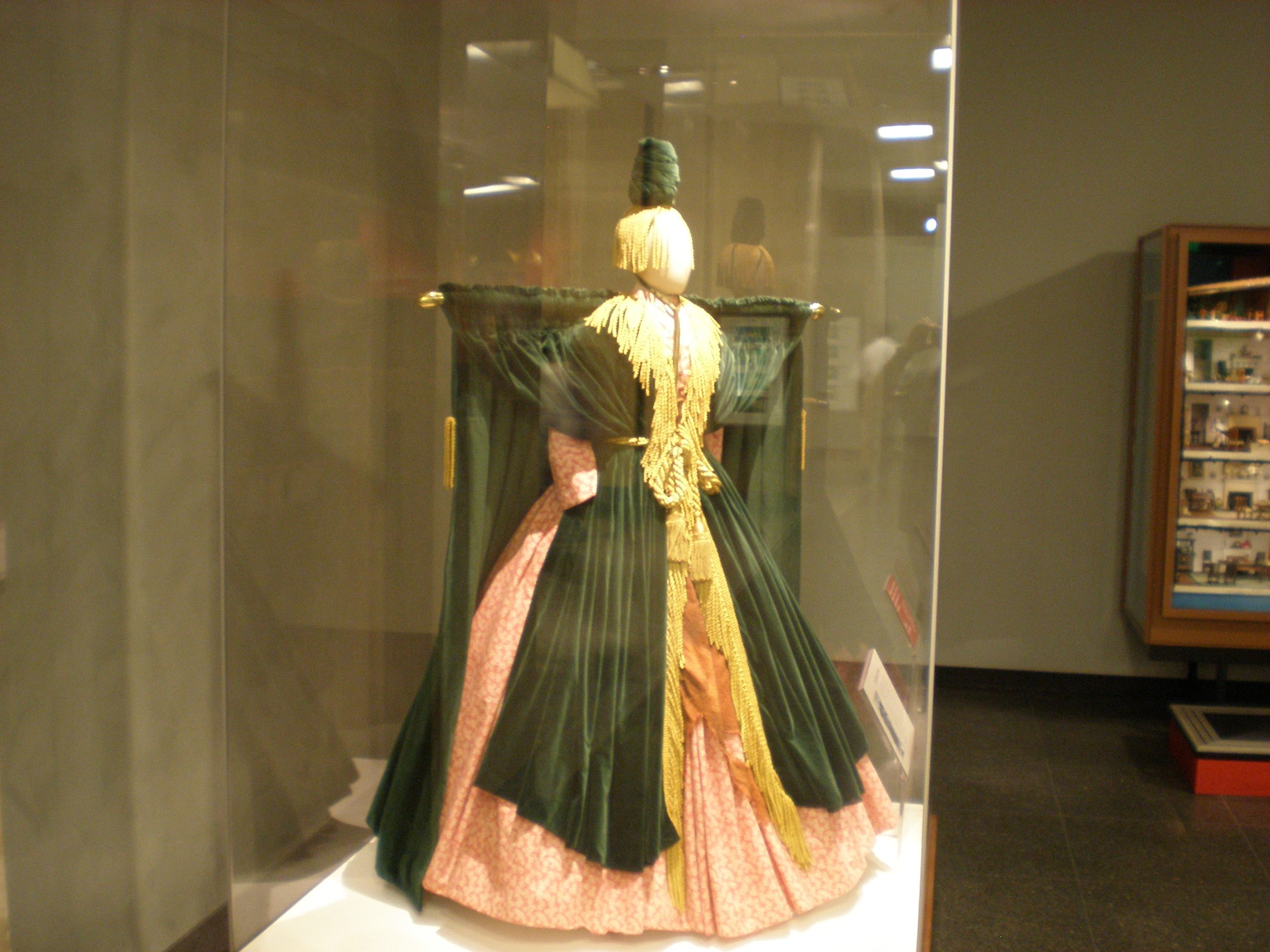 Bob Mackie's green velvet "curtain rod" dress from Carol Burnett's 1976 "Went With the Wind!" sketch, displayed on a mannequin in a glass case at the Smithsonian's National Museum of American History in 2010.