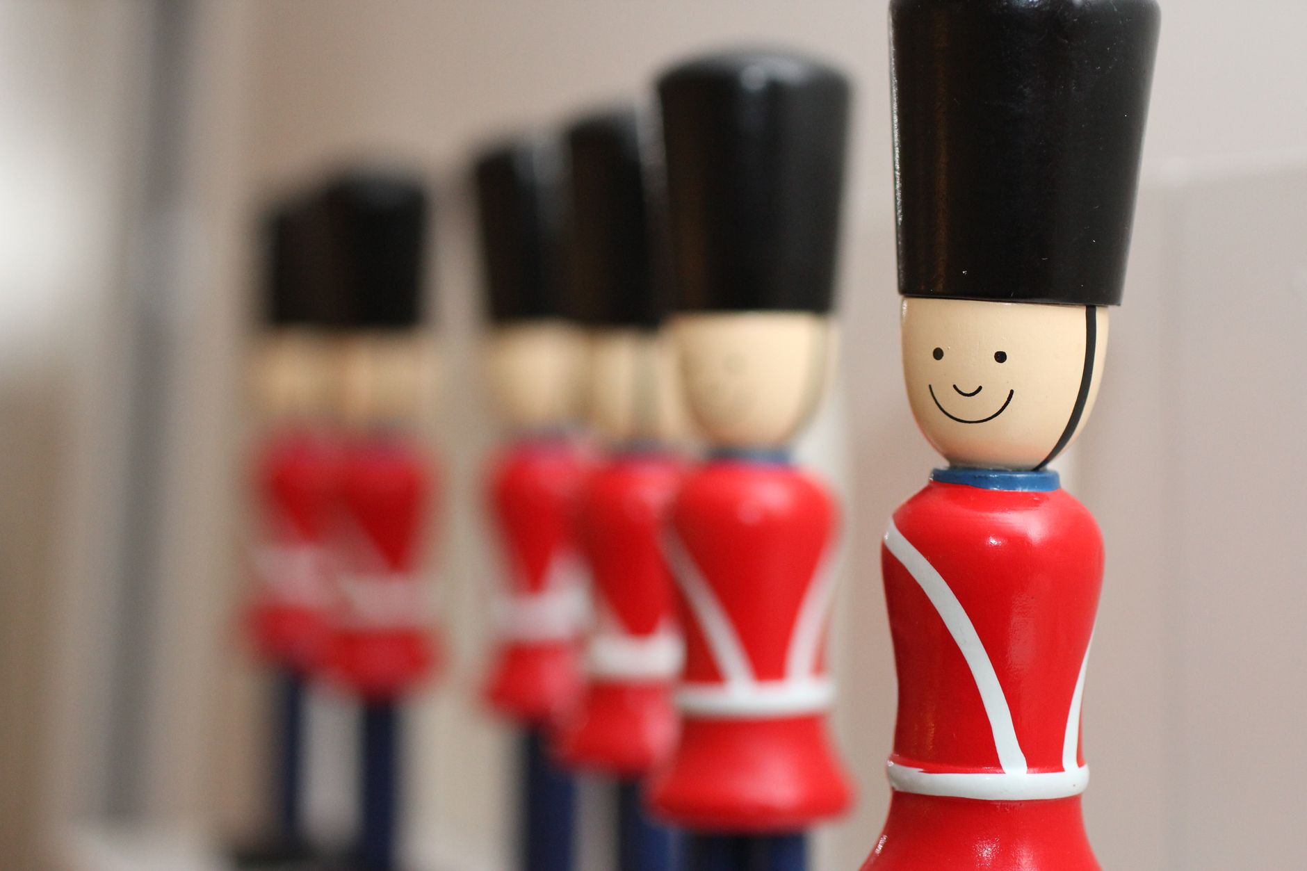 Photo: Rows of wooden toy soldiers in vibrant red uniforms captured in a close-up shot.