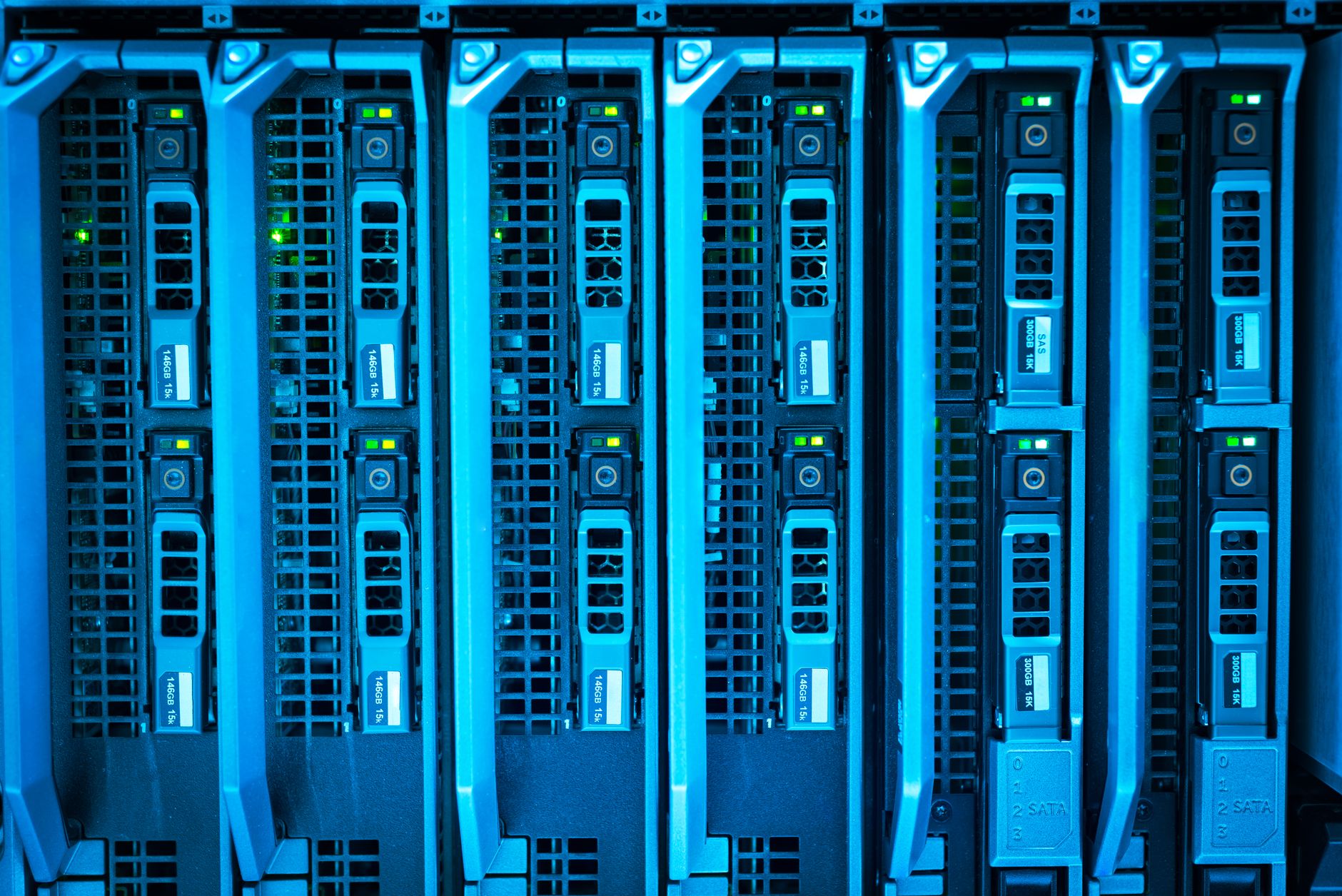 Photo: Detailed image of illuminated server racks showcasing modern technology infrastructure.