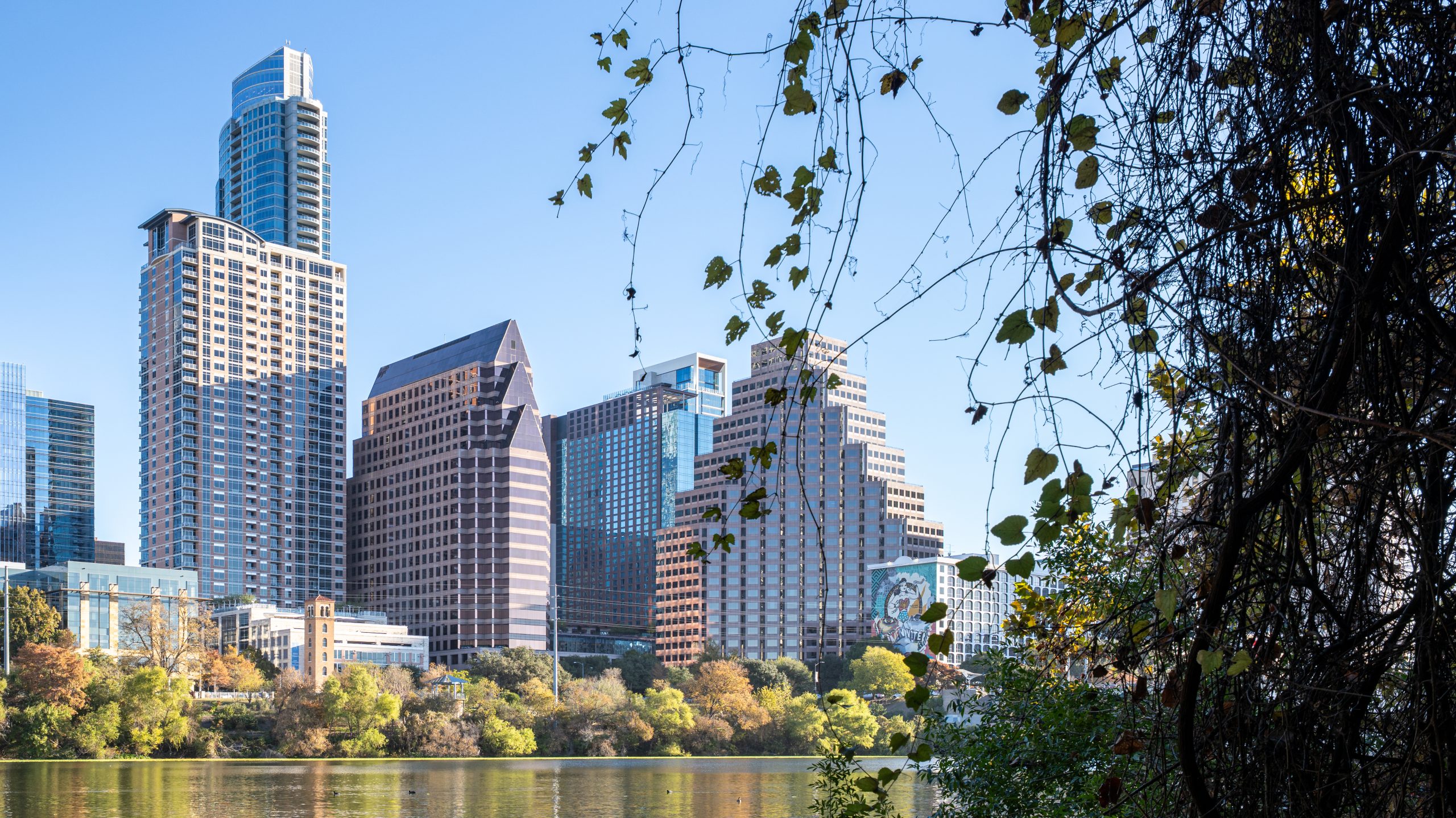 The downtown Austin skyline seen across Lady Bird Lake on a clear day.