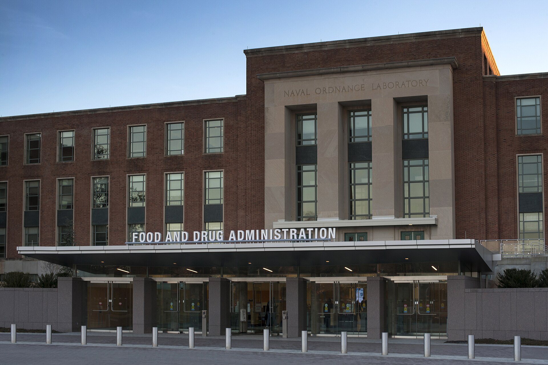 The main entrance of FDA Building 1 on the agency's White Oak campus in Silver Spring, Maryland, with the words Food and Drug Administration above the glass doors.