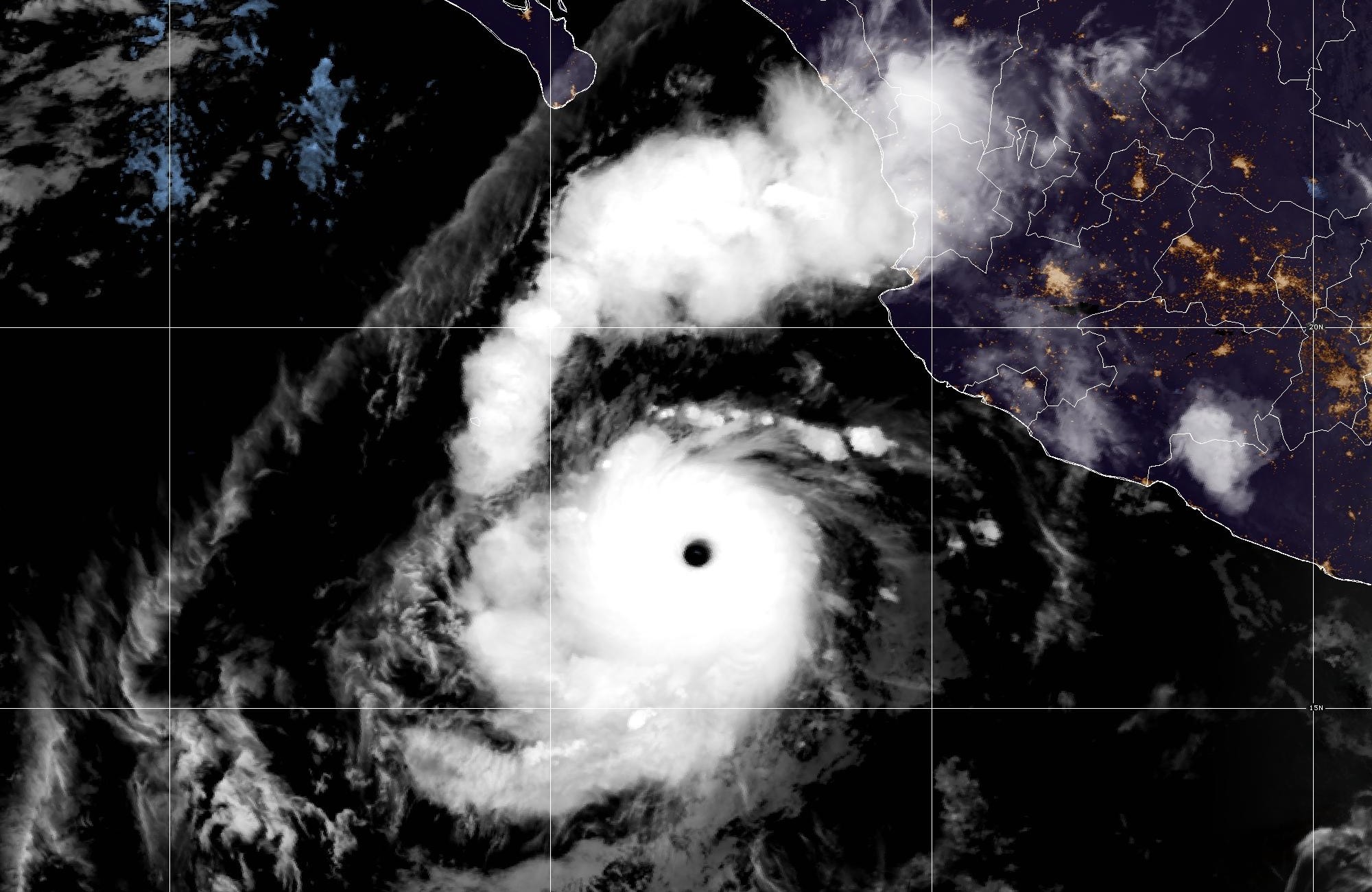 Satellite image of Hurricane Polo with a small, sharp eye over the eastern Pacific, southwest of mainland Mexico, with the tip of the Baja California peninsula at the top of the frame.