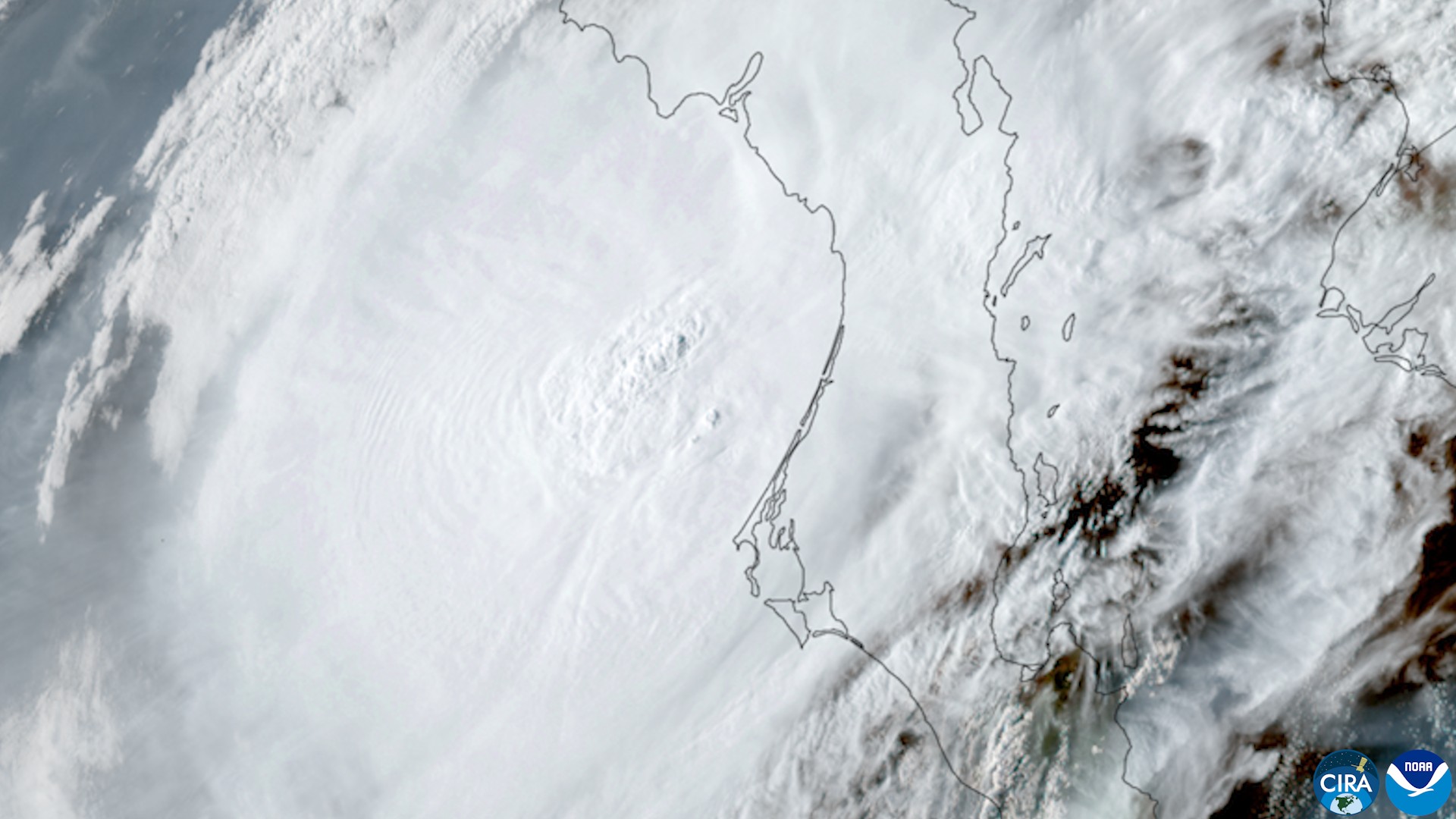 Satellite view of Hurricane Polo's dense cloud mass over Baja California Sur, with the coastlines of the peninsula and mainland Mexico outlined.