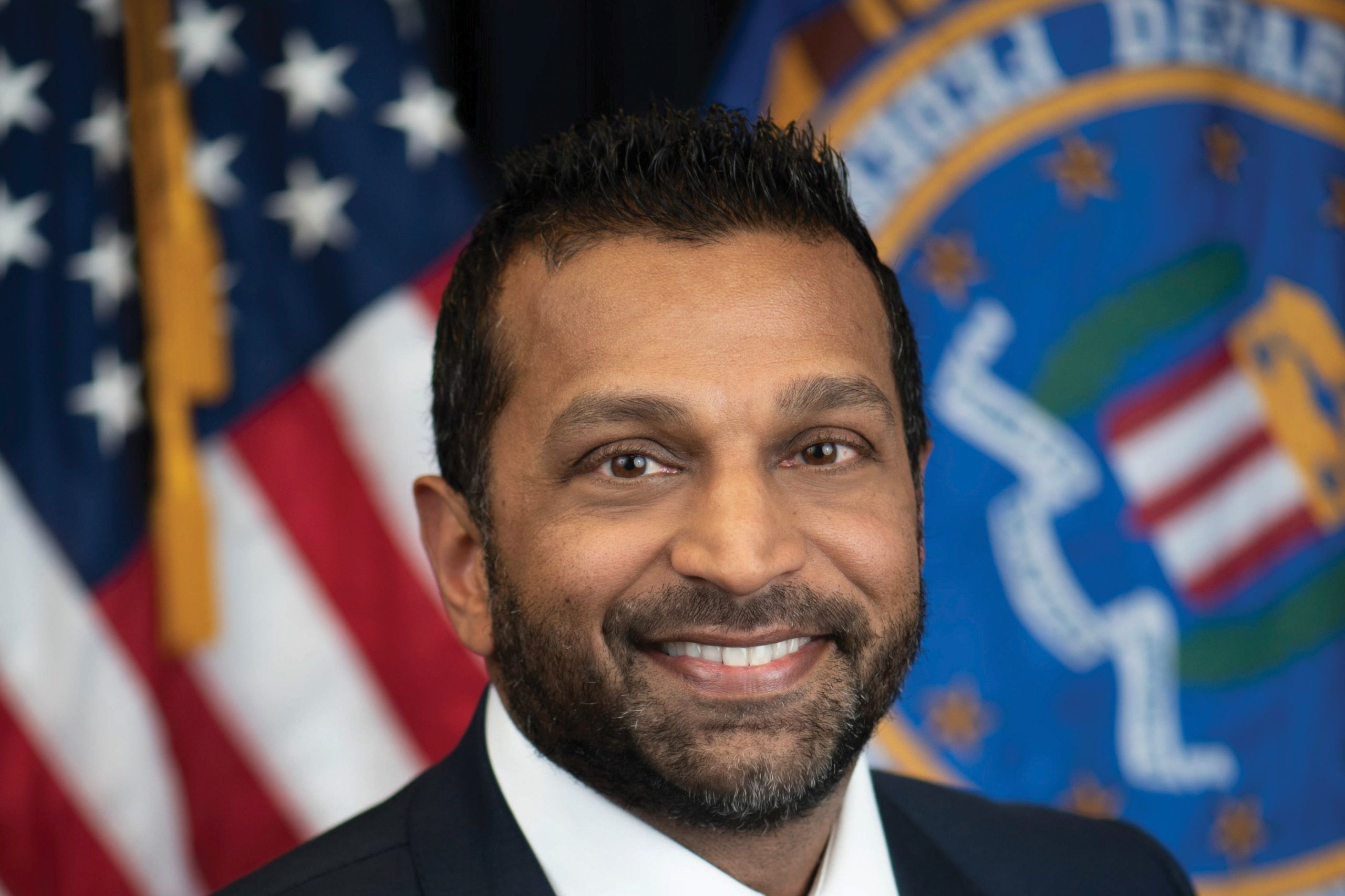 FBI Director Kash Patel in his official FBI portrait, in front of a U.S. flag and the FBI flag.