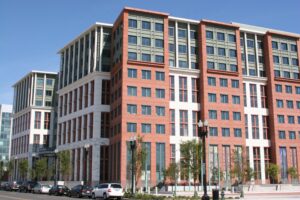 The U.S. Department of Transportation headquarters building in Southeast Washington, a red-and-white stone office block with rows of windows.