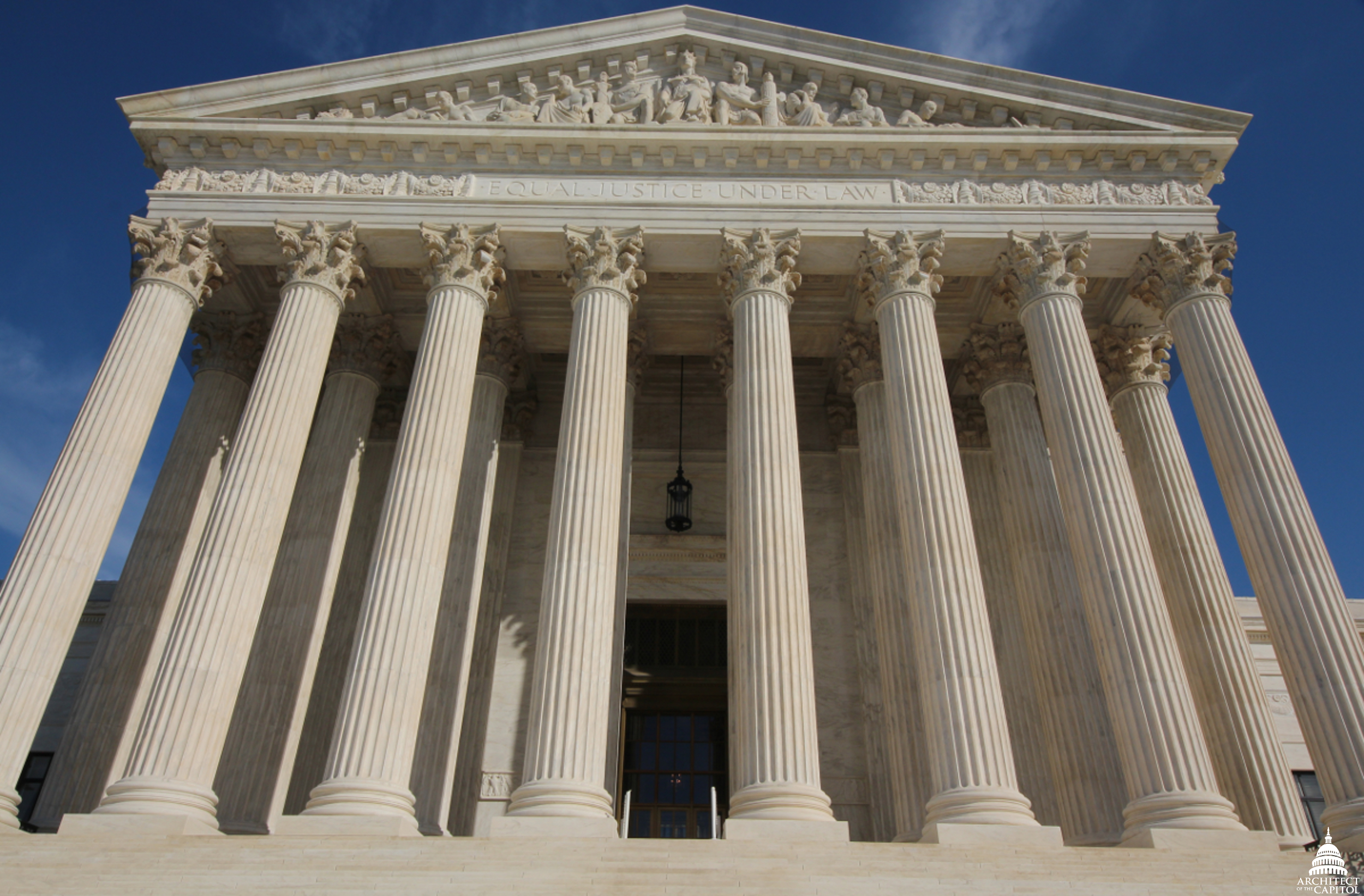The west front of the U.S. Supreme Court Building in Washington, with its marble columns and the words Equal Justice Under Law carved above them.