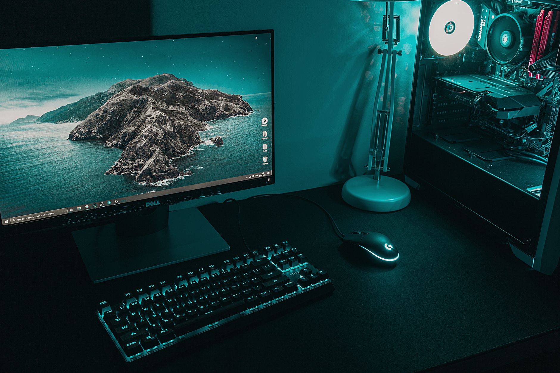 A desktop computer setup with a monitor showing the Windows taskbar, a mechanical keyboard, a mouse, and an open PC tower.