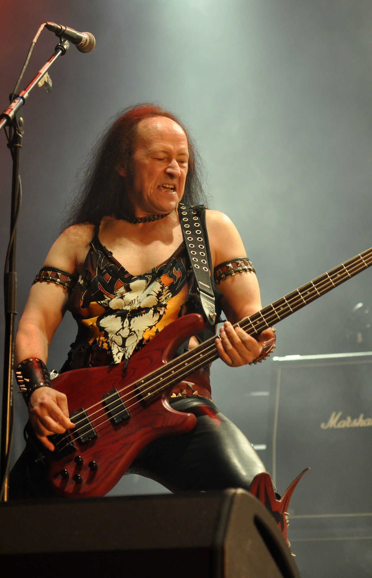 Conrad "Cronos" Lant of Venom playing bass on stage at the Party.San Metal Open Air festival in 2013.
