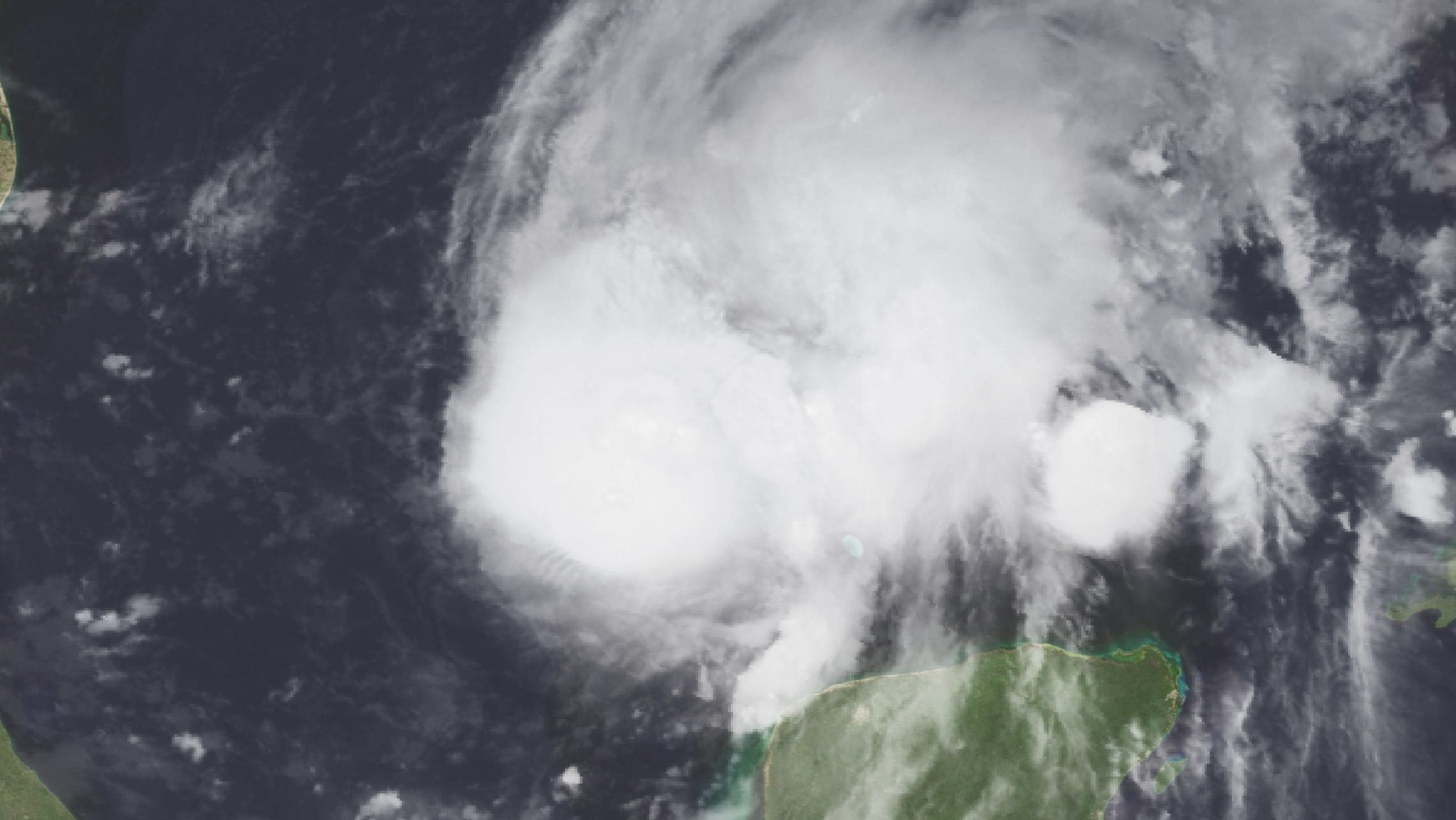 Satellite image of Hurricane Isaias over the Gulf, with a large white cloud mass north of the Yucatan Peninsula.